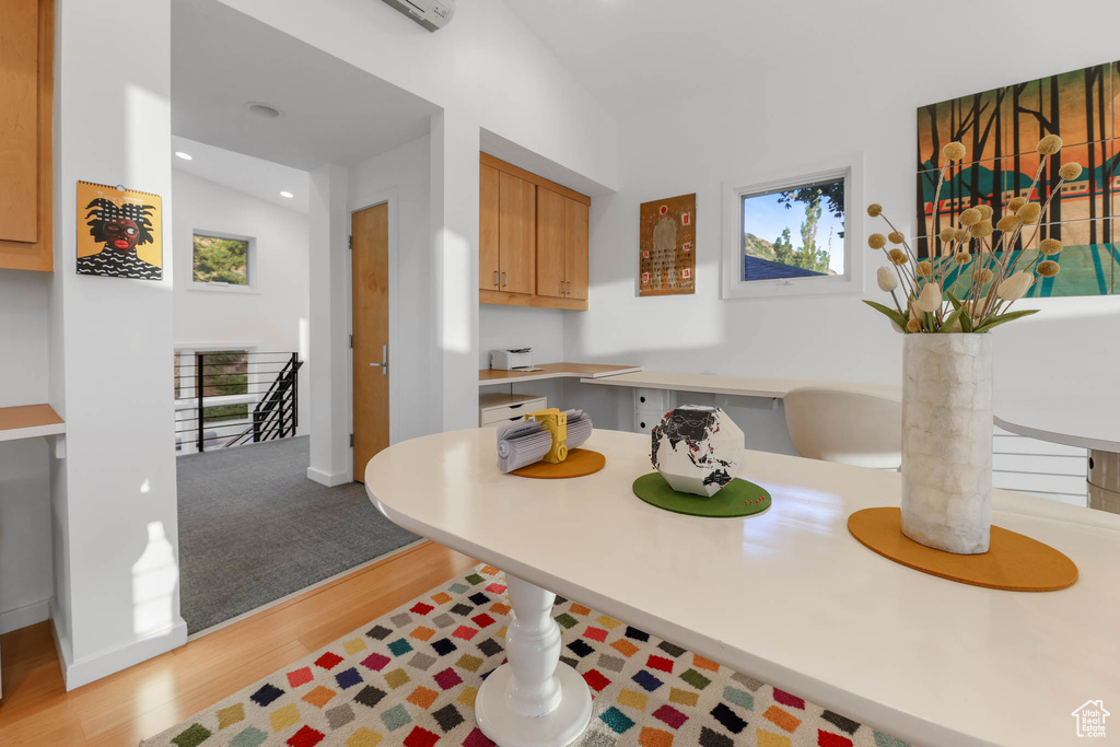 Kitchen with wood finished floors, light countertops, recessed lighting, and baseboards