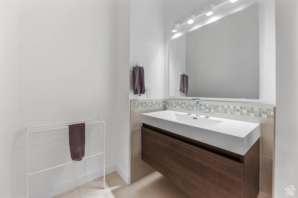 Bathroom with vanity, tile patterned flooring, and tasteful backsplash