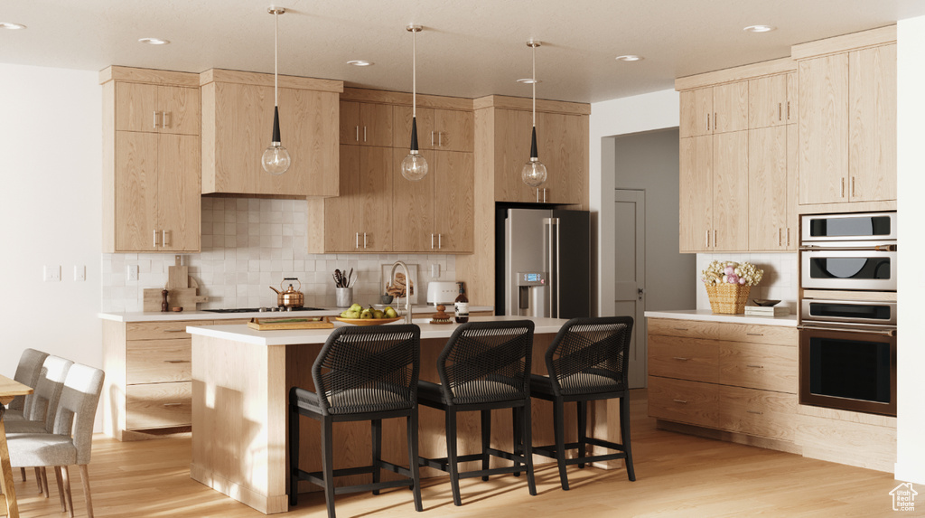 Kitchen with light brown cabinets, stainless steel fridge with ice dispenser, light countertops, light wood finished floors, and recessed lighting