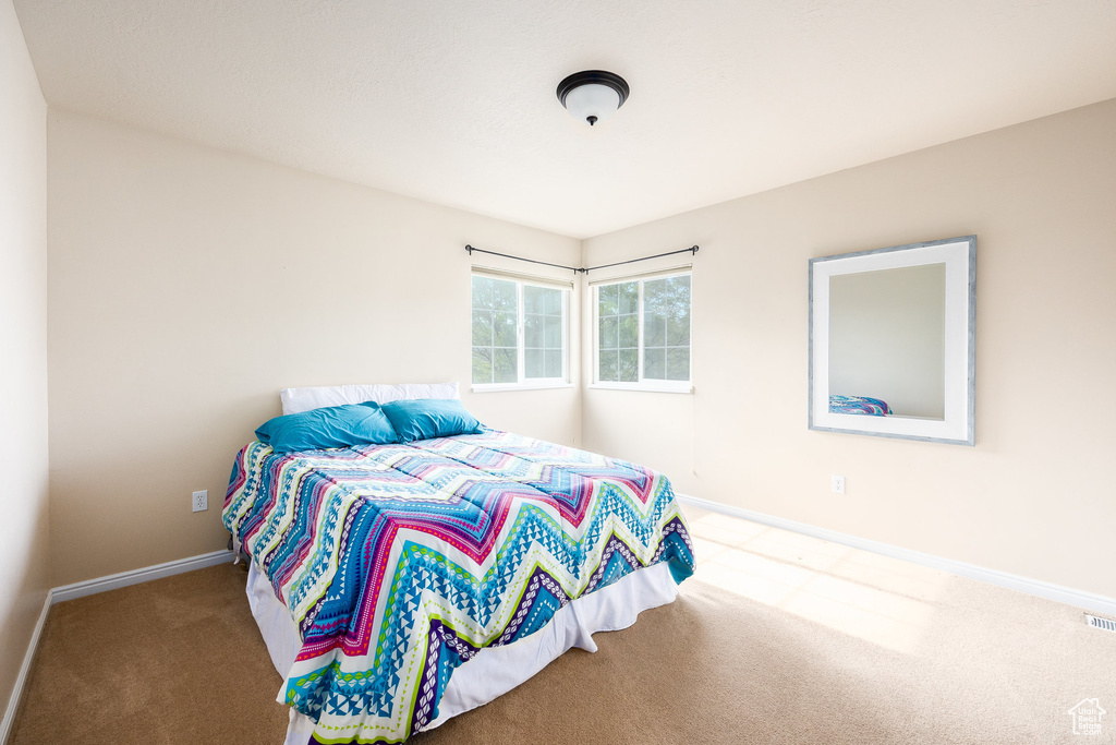 Carpeted bedroom featuring baseboards