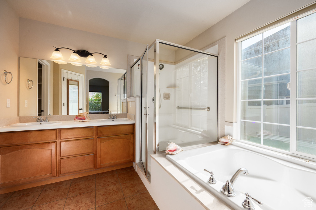 Full bath featuring a stall shower, a bath, plenty of natural light, and tile patterned flooring