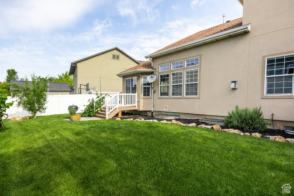 Back of property featuring stucco siding