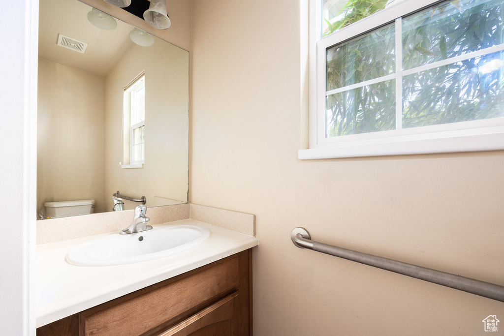 Half bath featuring vanity and toilet