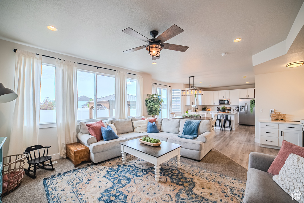 Living area featuring ceiling fan, recessed lighting, and light wood finished floors