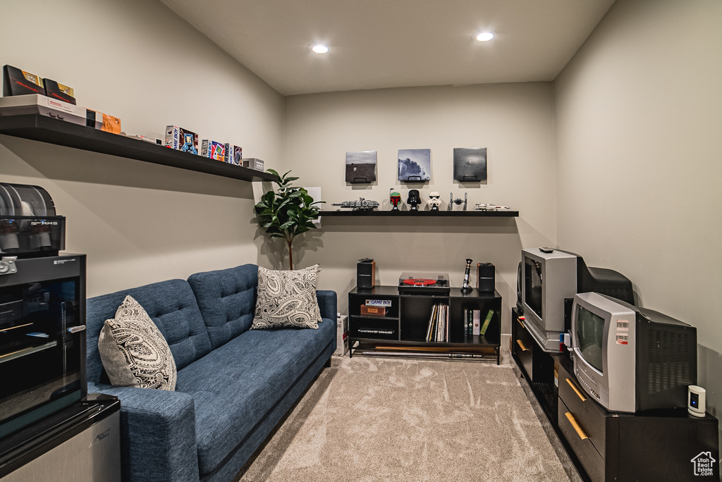 Carpeted living area with recessed lighting