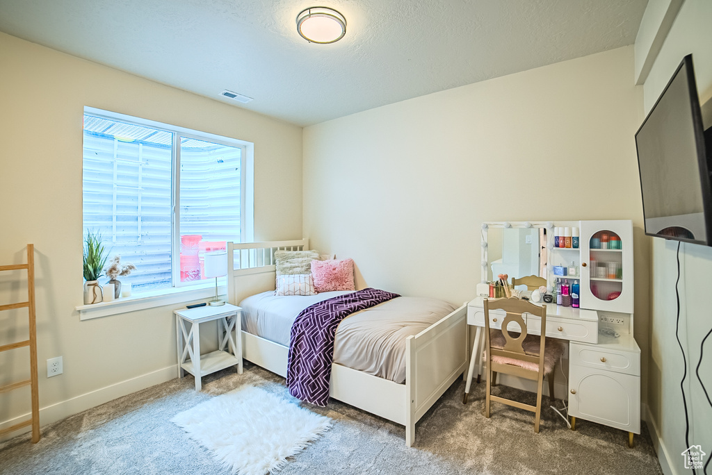 Bedroom featuring carpet flooring and baseboards