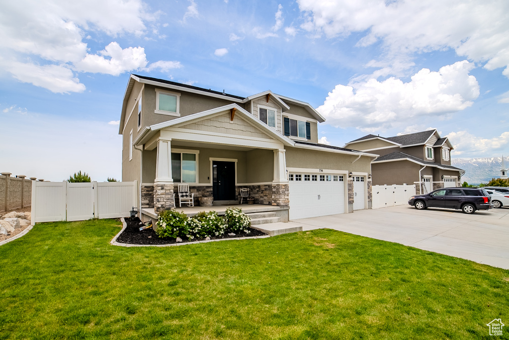 Craftsman-style house featuring a porch, stone siding, concrete driveway, and stucco siding
