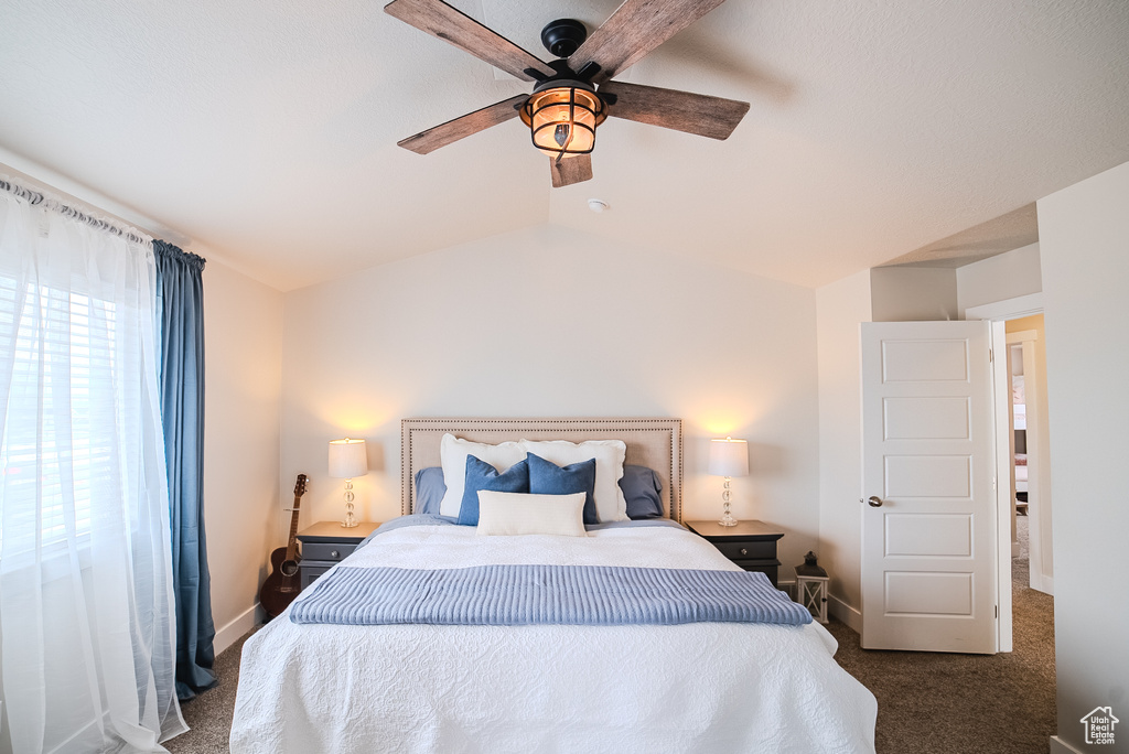Bedroom featuring carpet floors, ceiling fan, lofted ceiling, and baseboards