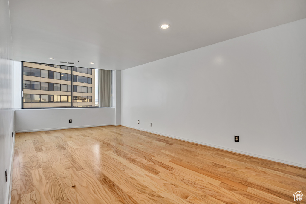 Empty room with wood finished floors and recessed lighting