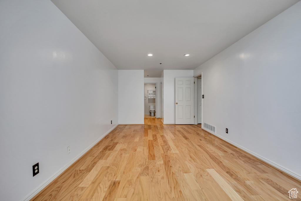 Empty room featuring recessed lighting, light wood finished floors, and baseboards