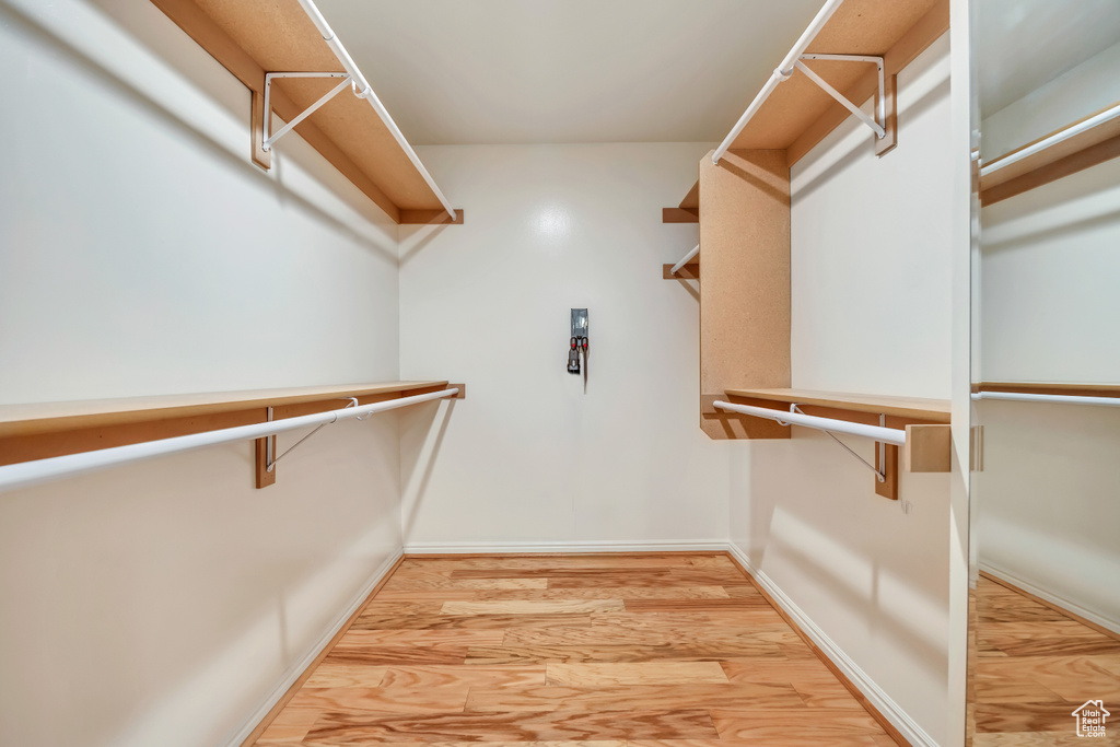 Spacious closet with light wood-type flooring