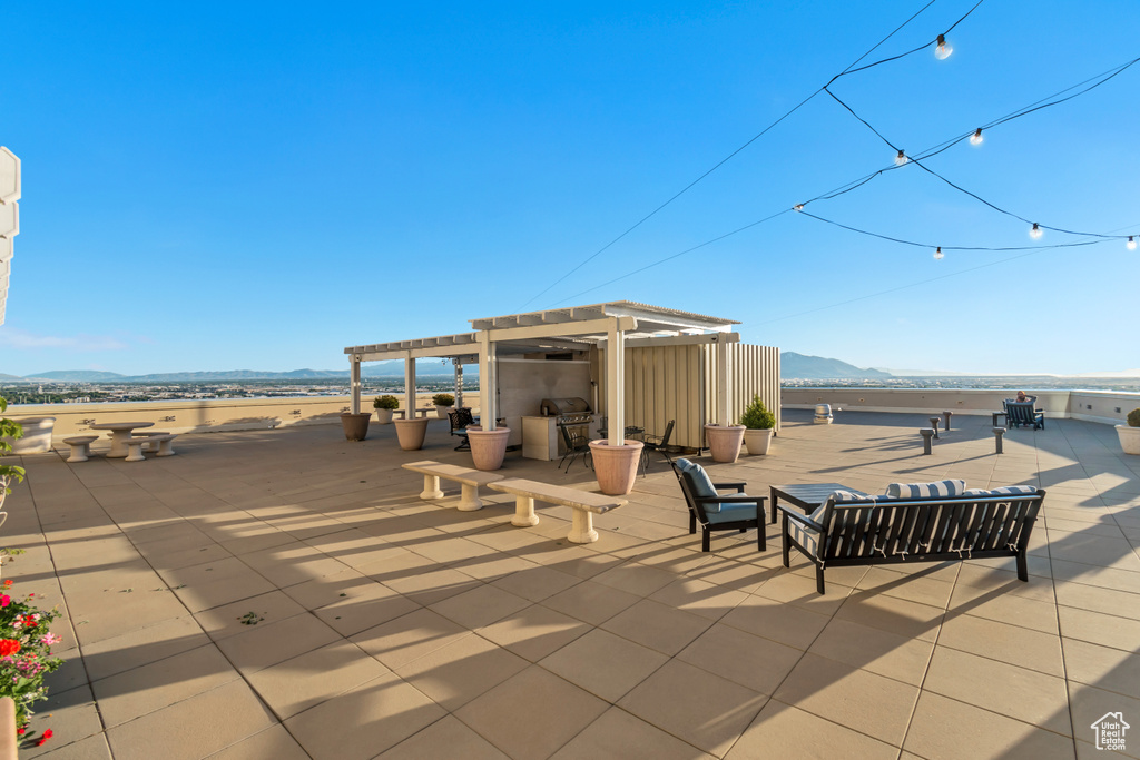 View of patio / terrace featuring a mountain view, a pergola, area for grilling, and an outdoor hangout area