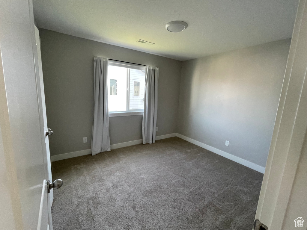 Unfurnished room with carpet and baseboards