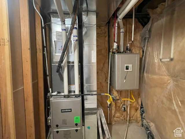 Utility room featuring heating unit
