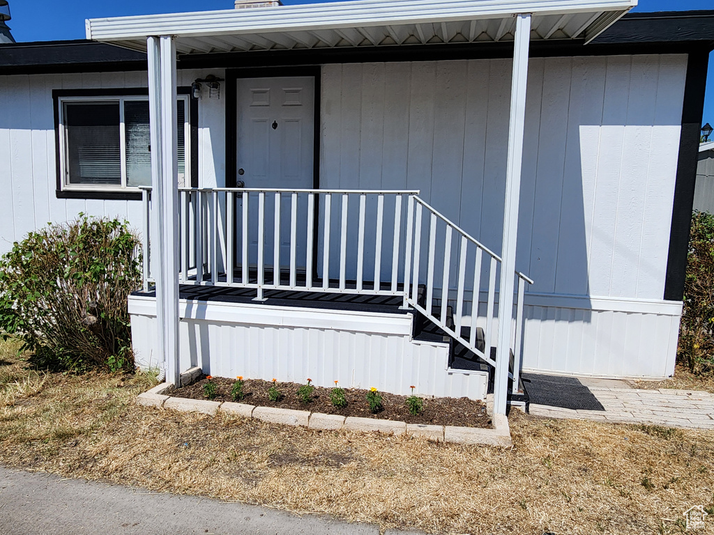 Entrance to property featuring covered porch