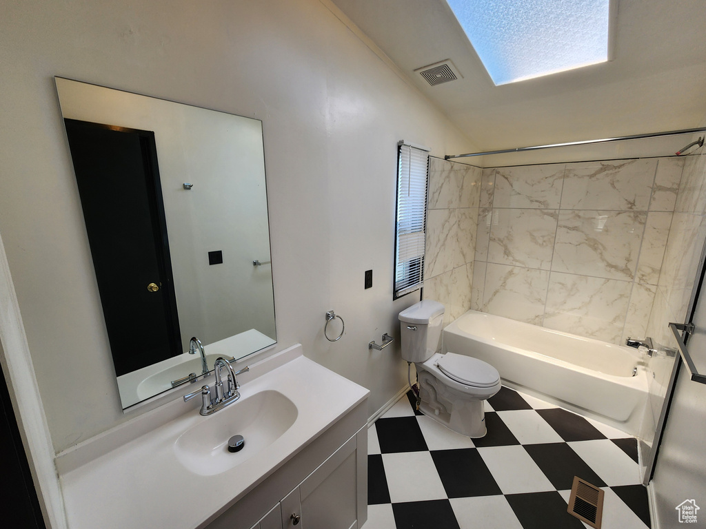 Full bathroom featuring toilet, washtub / shower combination, tile patterned floors, and vanity