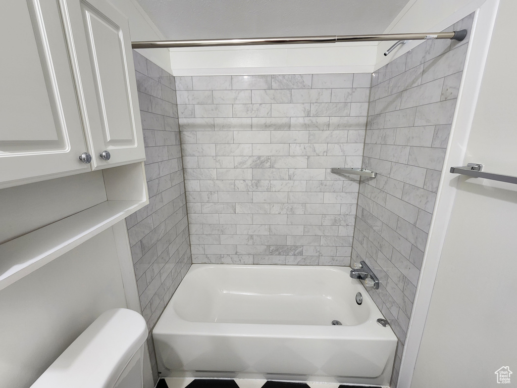 Bathroom with toilet and shower / bath combination
