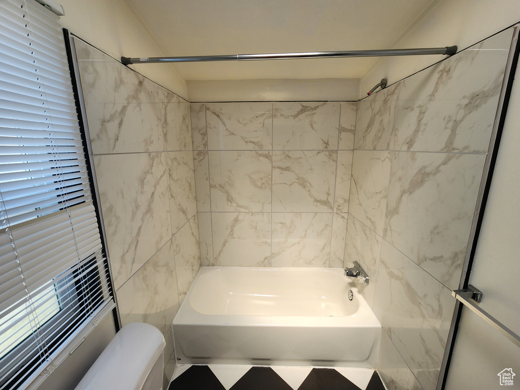 Full bathroom with shower / tub combination and toilet
