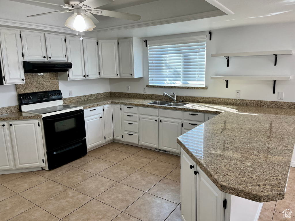 Kitchen featuring electric range, a sink, under cabinet range hood, a ceiling fan, and white cabinetry