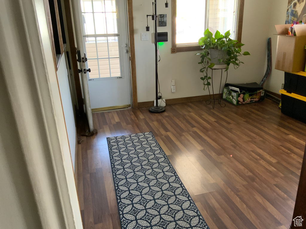 Entryway with wood finished floors and baseboards