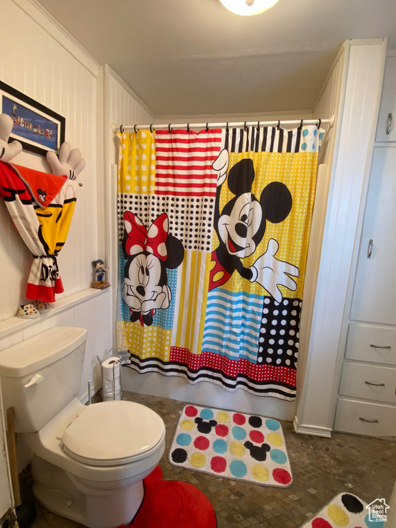 Full bath featuring toilet and curtained shower
