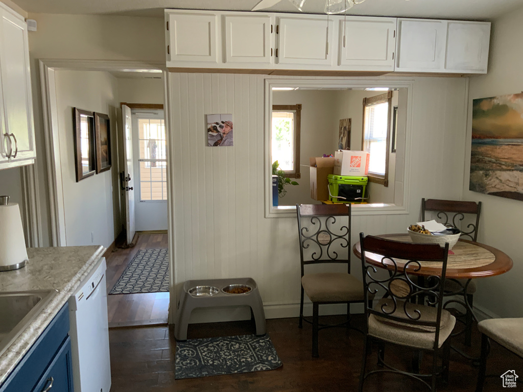 Dining space featuring dark wood-type flooring and baseboards