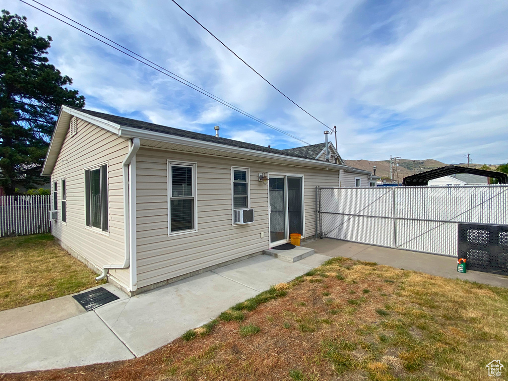 Back of house featuring cooling unit and a patio area