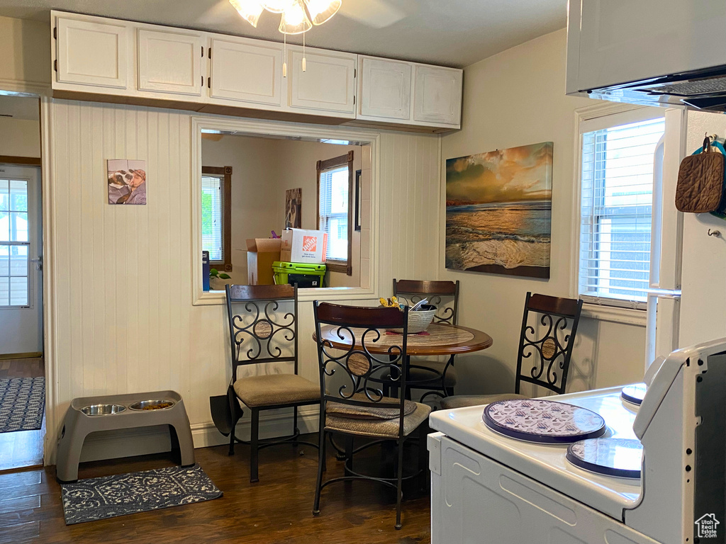 Dining area with dark wood finished floors, plenty of natural light, and ceiling fan