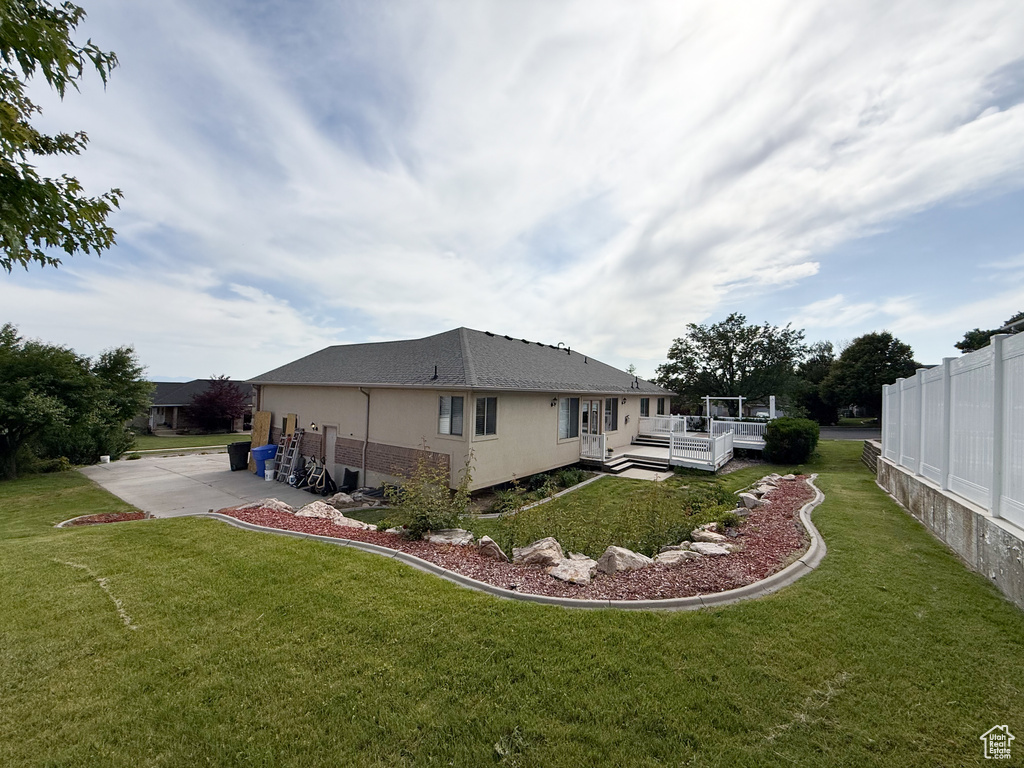 Rear view of property featuring a wooden deck