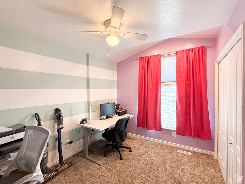 Office with carpet floors, lofted ceiling, a ceiling fan, and baseboards