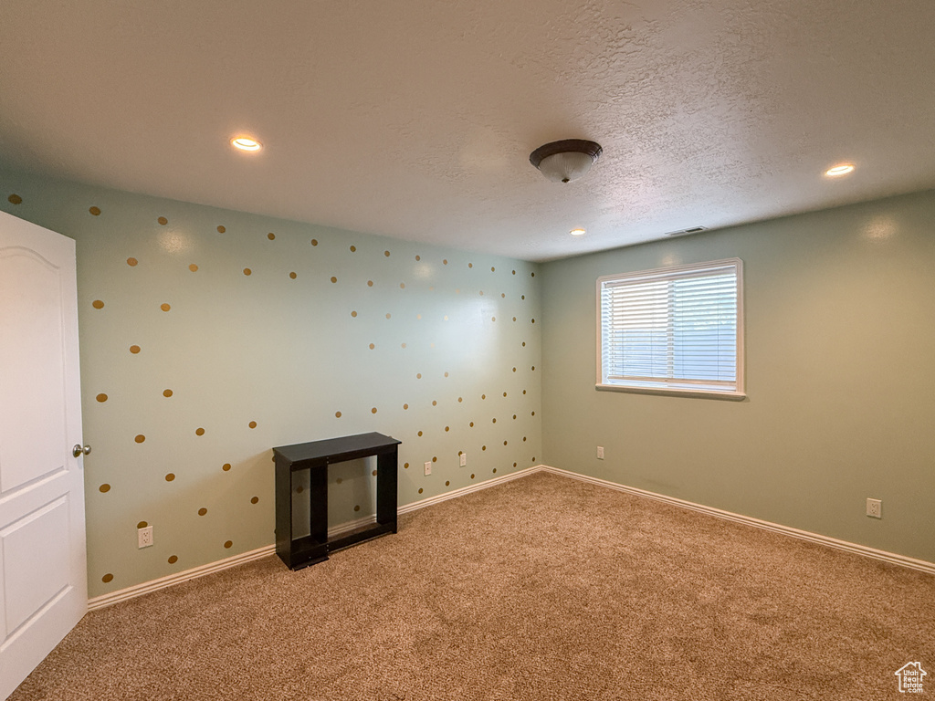 Unfurnished room with carpet flooring, a textured ceiling, recessed lighting, and baseboards