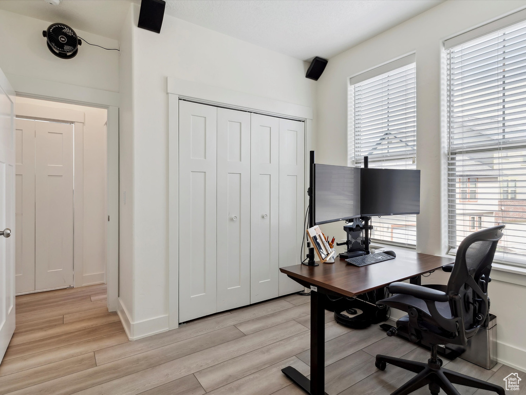 Office with light wood finished floors and baseboards