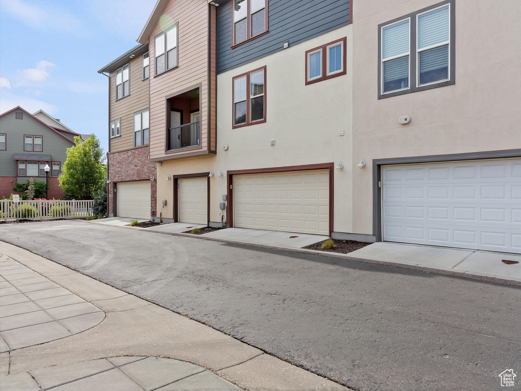 View of front facade featuring a garage and stucco siding