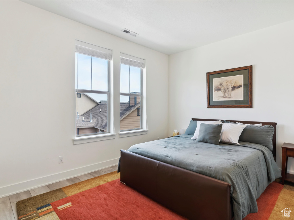 Bedroom featuring light wood-style flooring and baseboards