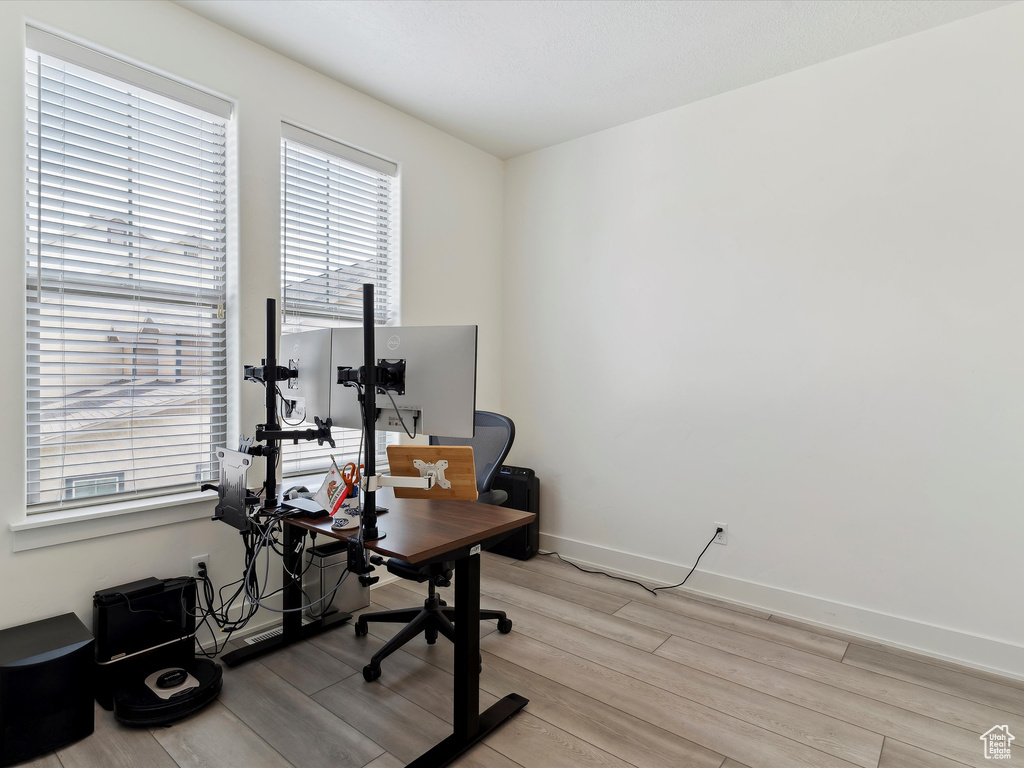 Office area featuring light wood-type flooring and baseboards