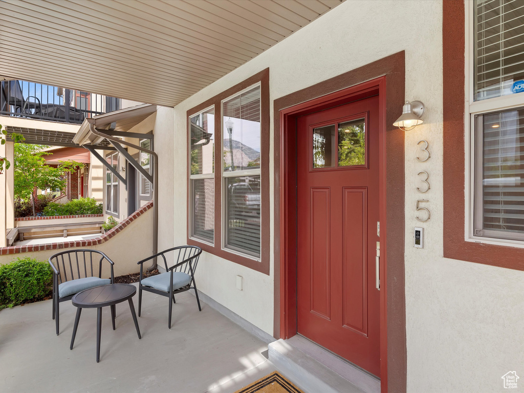 Entrance to property featuring stucco siding and a porch