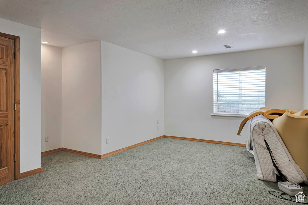 Unfurnished bedroom featuring carpet floors, baseboards, recessed lighting, and a textured ceiling