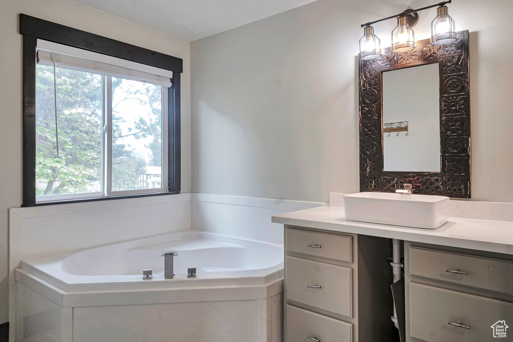 Bathroom featuring vanity and a garden tub