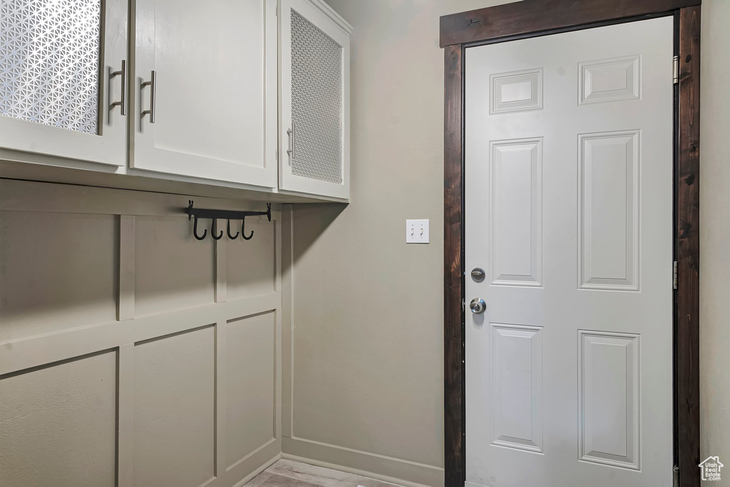 Mudroom featuring baseboards and wood finished floors