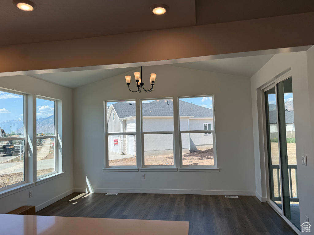 Unfurnished dining area with lofted ceiling, dark wood-type flooring, a chandelier, baseboards, and recessed lighting