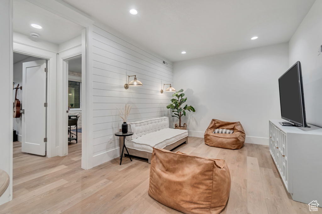 Living area with light wood-type flooring, recessed lighting, and baseboards