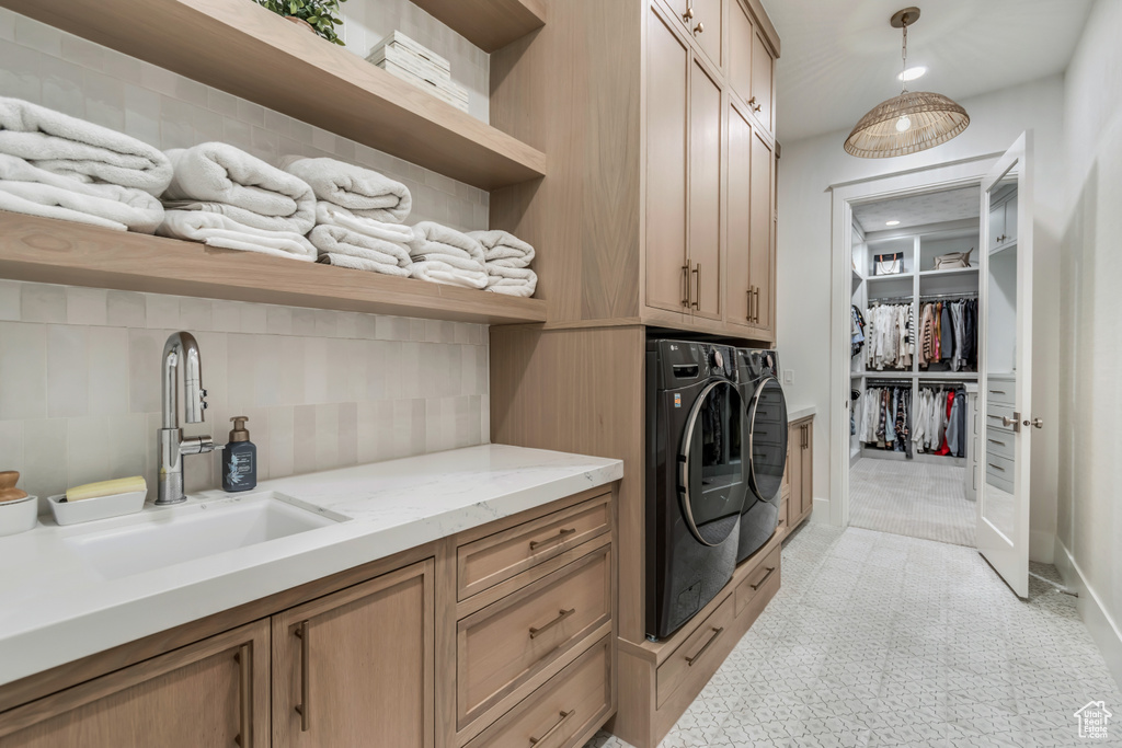 Washroom with washing machine and dryer and cabinet space