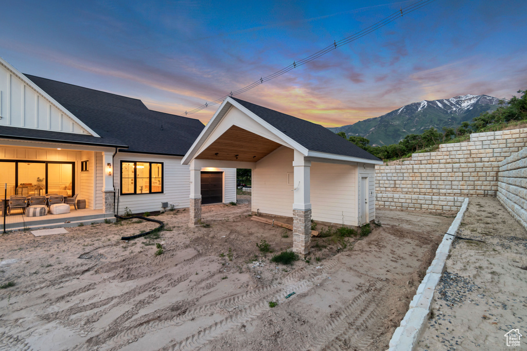 Back of house with board and batten siding and a mountain view