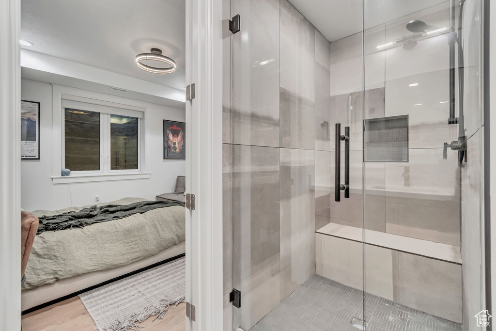 Full bath featuring connected bathroom and a shower stall