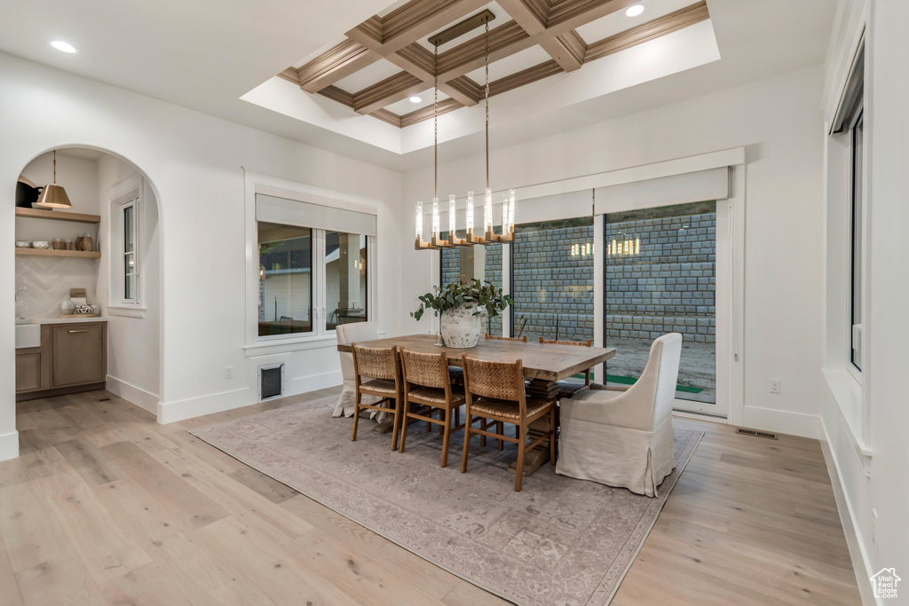 Dining room with light wood-style flooring, coffered ceiling, beam ceiling, baseboards, and recessed lighting