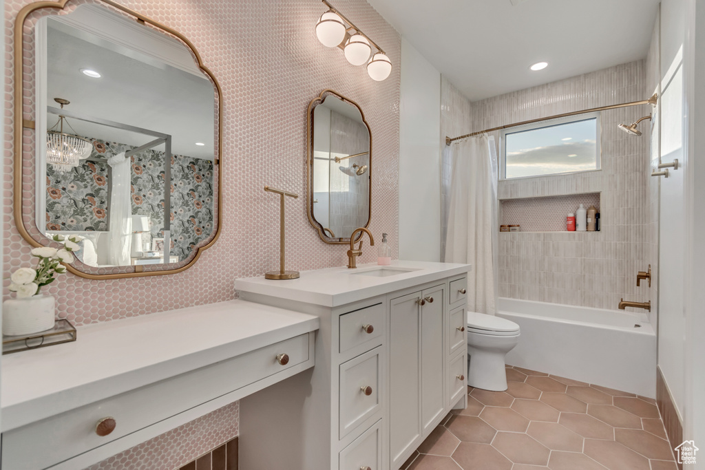 Bathroom featuring shower / bath combination with curtain, tile patterned flooring, toilet, and vanity