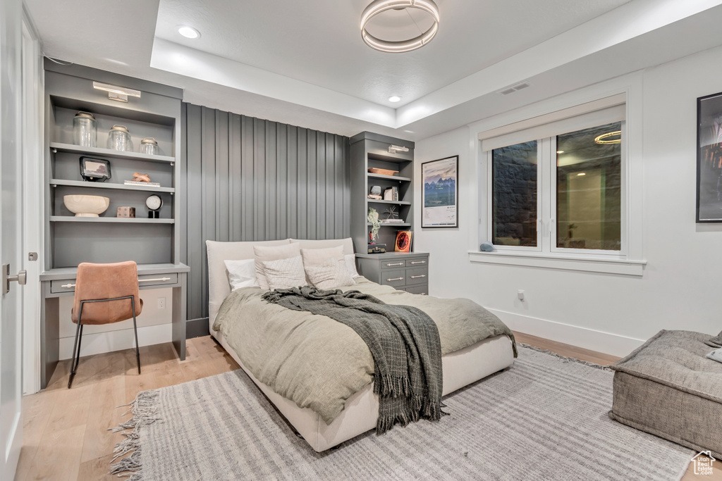 Bedroom with light wood-style floors, baseboards, and recessed lighting