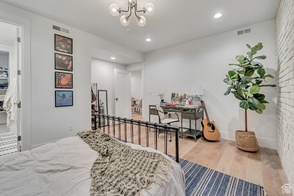 Bedroom featuring wood finished floors, a chandelier, recessed lighting, an office area, and baseboards