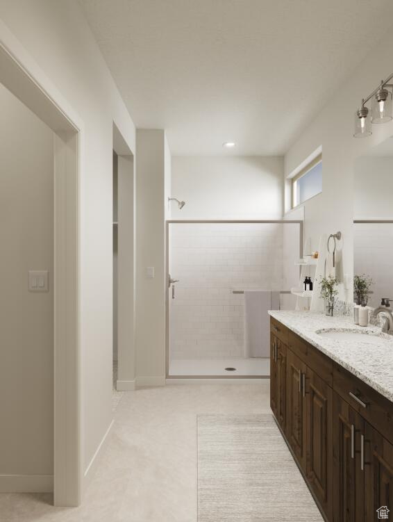 Bathroom with vanity and tiled shower