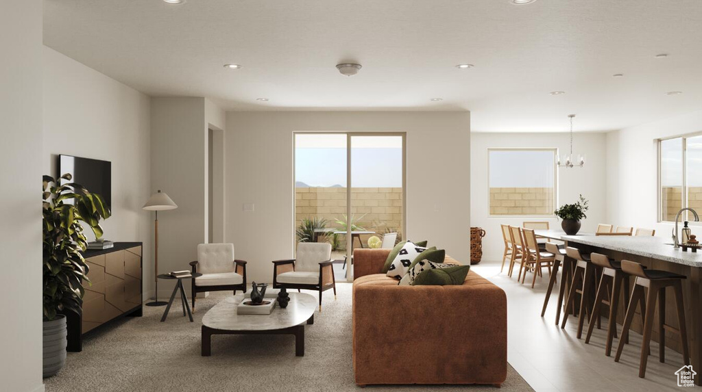 Living room with plenty of natural light, recessed lighting, and a chandelier